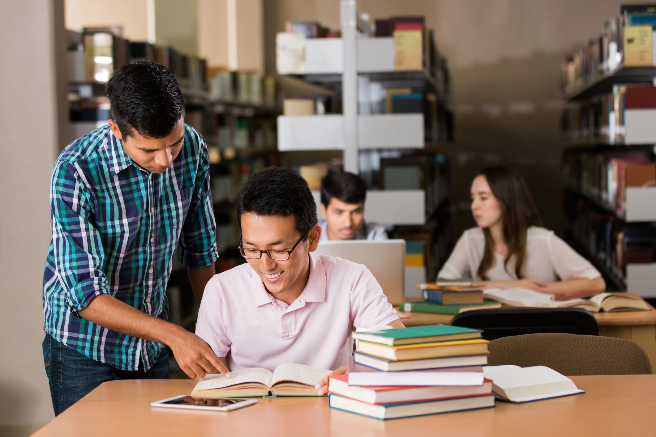 Small group studying together with books
